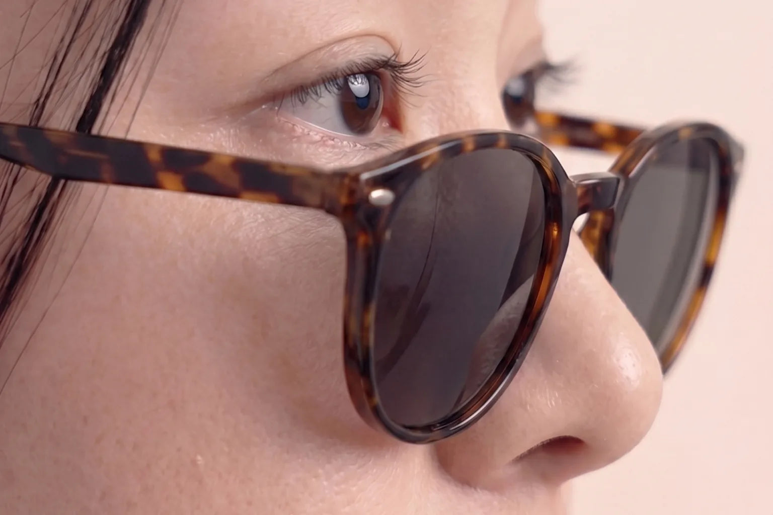 Close-up of sunglasses sliding down Asian nose bridge, showing common fit problem