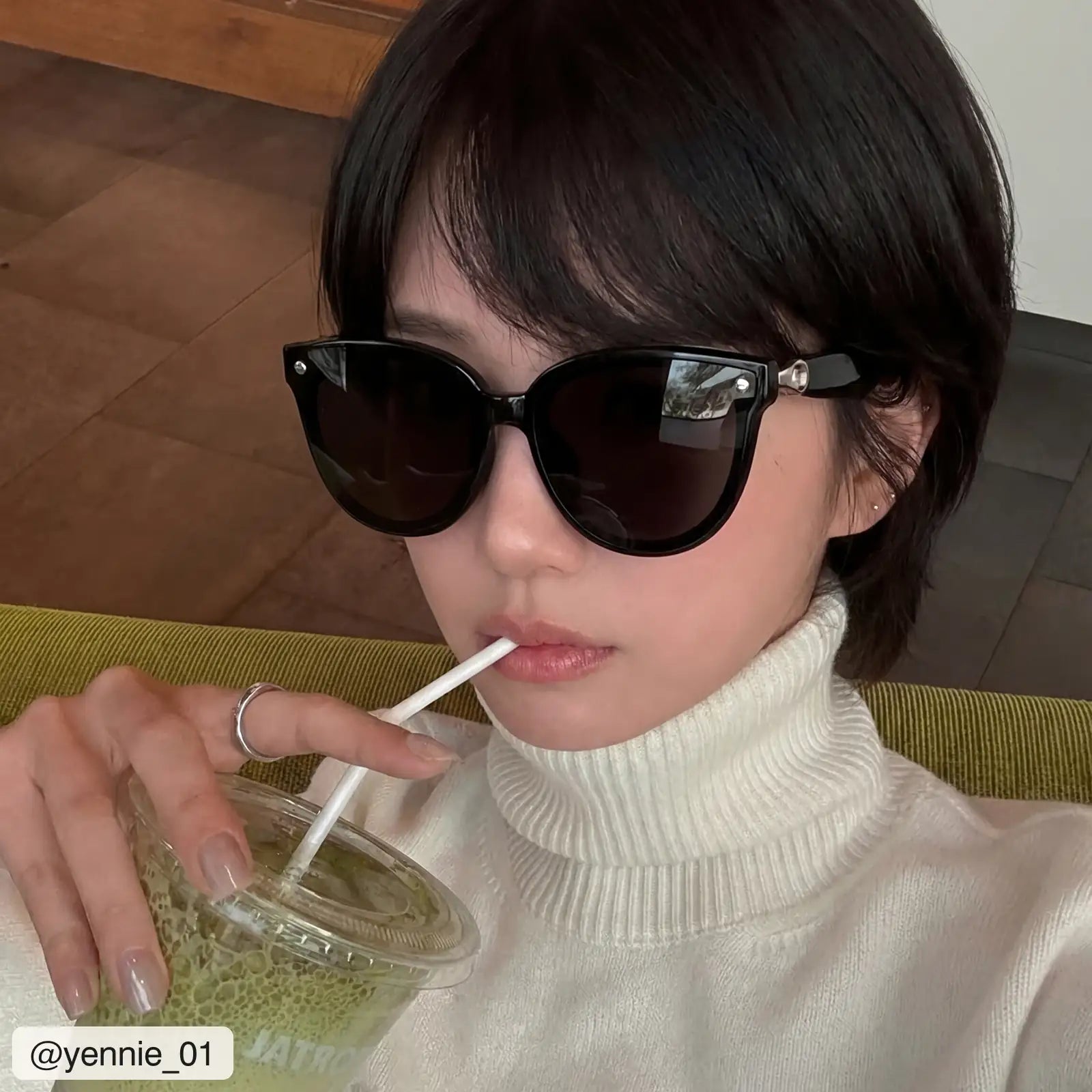 @yennie_01 wearing Sweet Pain NANA G1 sunglasses in graphite, cafe lifestyle shot