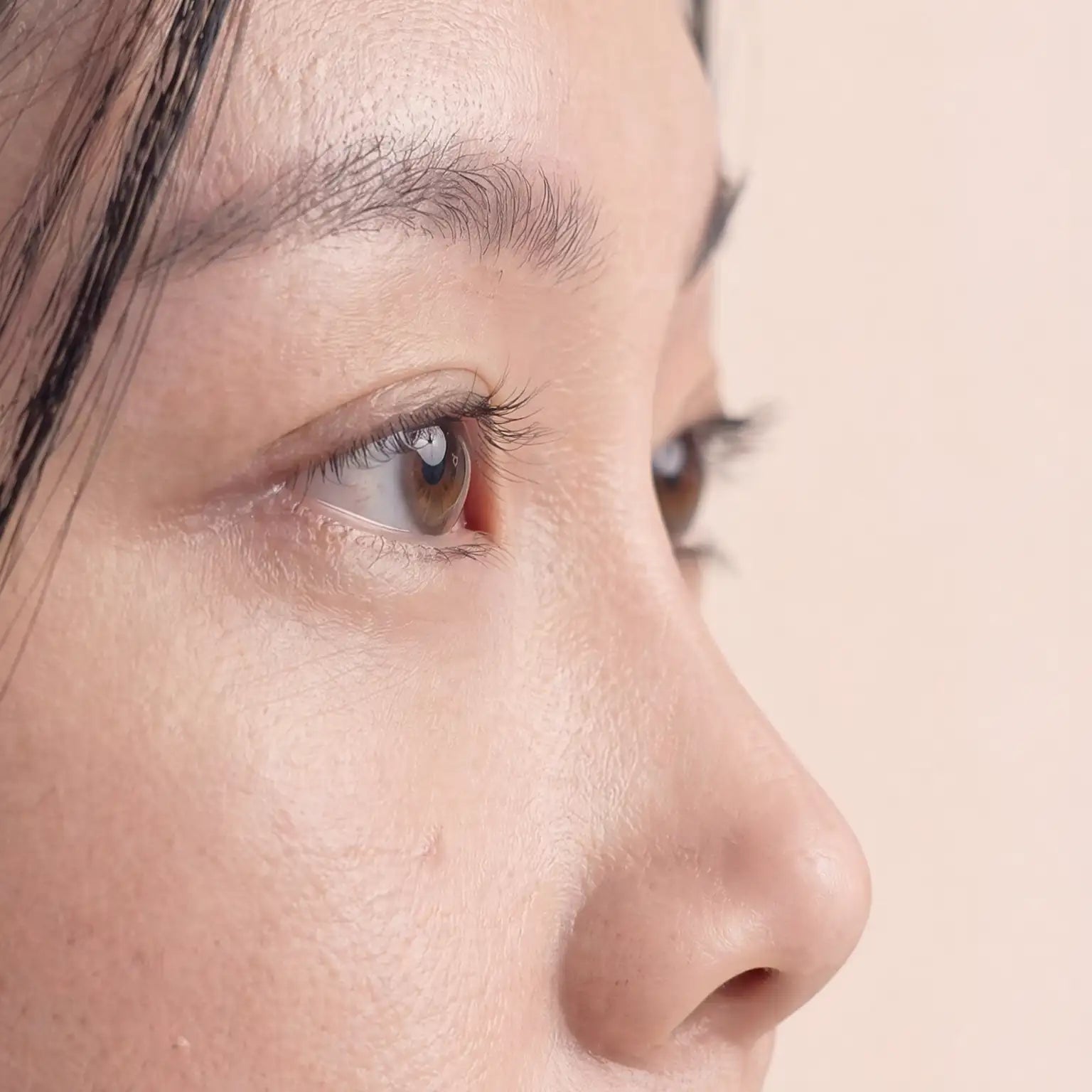 Close-up of Asian woman's low nose bridge profile, illustrating fit challenge