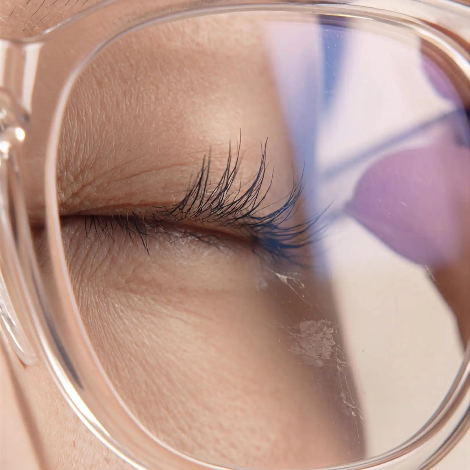 Close-up of eyelashes touching sunglasses lens due to insufficient nose bridge clearance