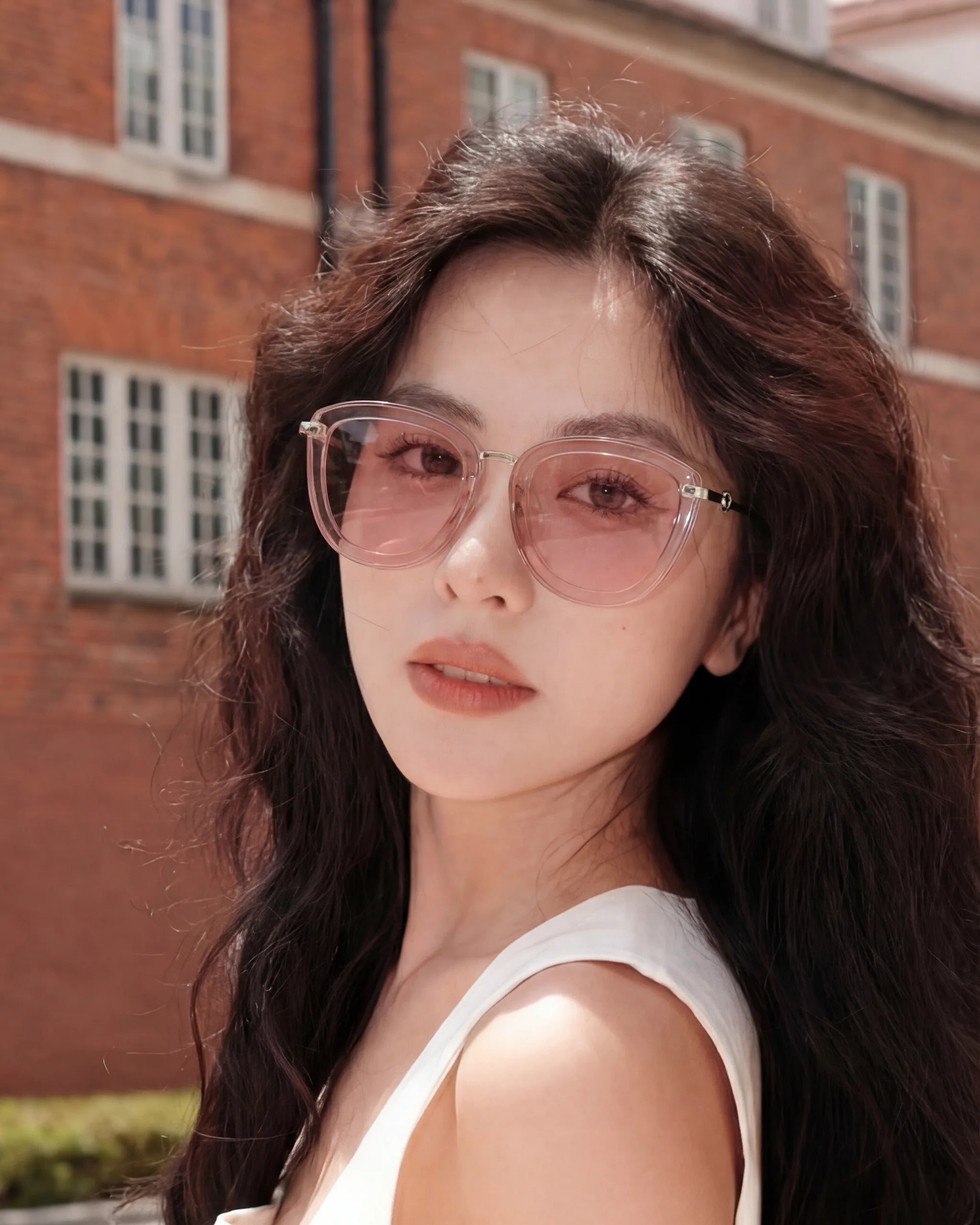Woman wearing Sweet Pain JULIA R1 sunglasses in rosé, outdoor portrait