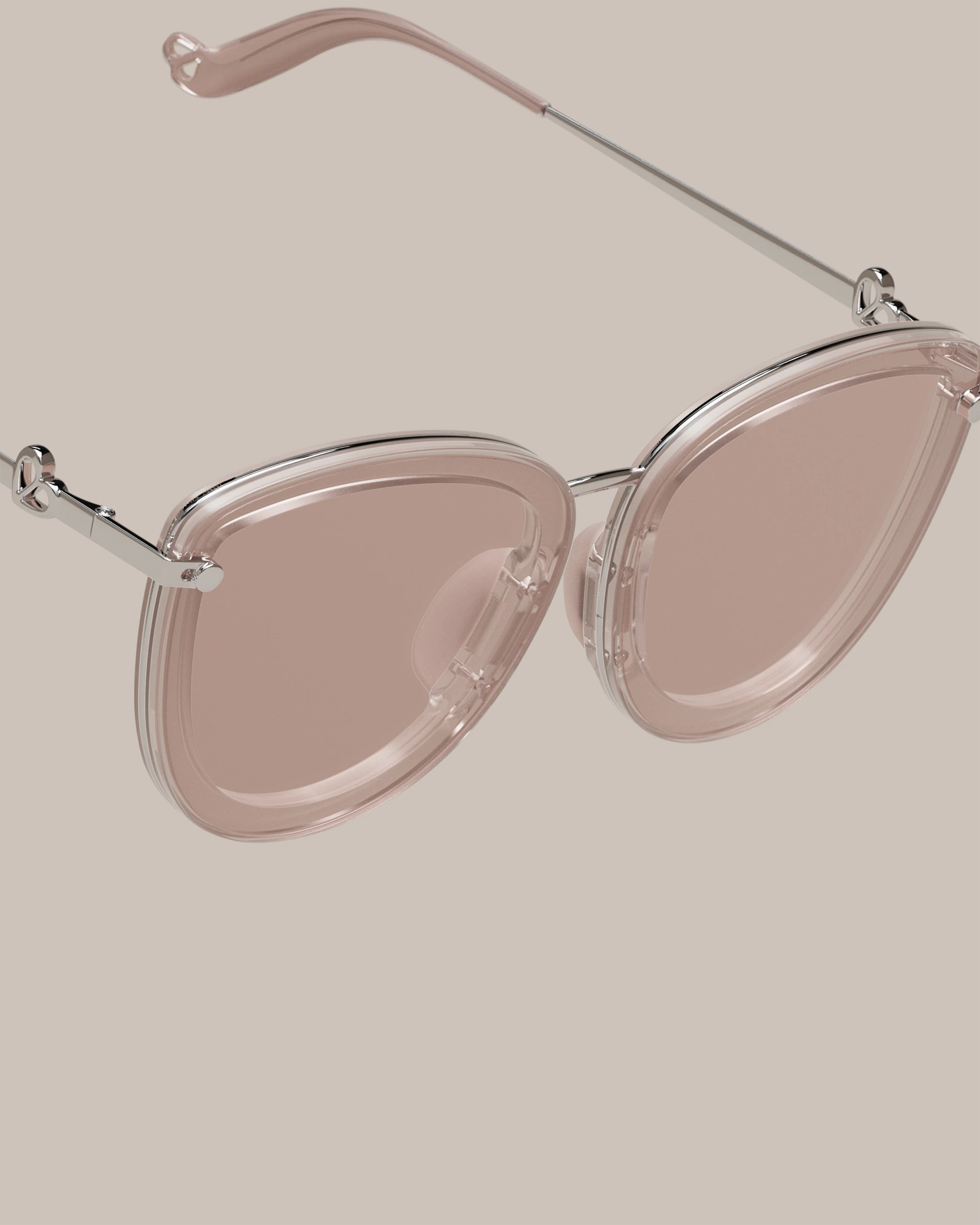 Sweet Pain JULIA R1 sunglasses close-up showing edgeless rimless lens design in rosé