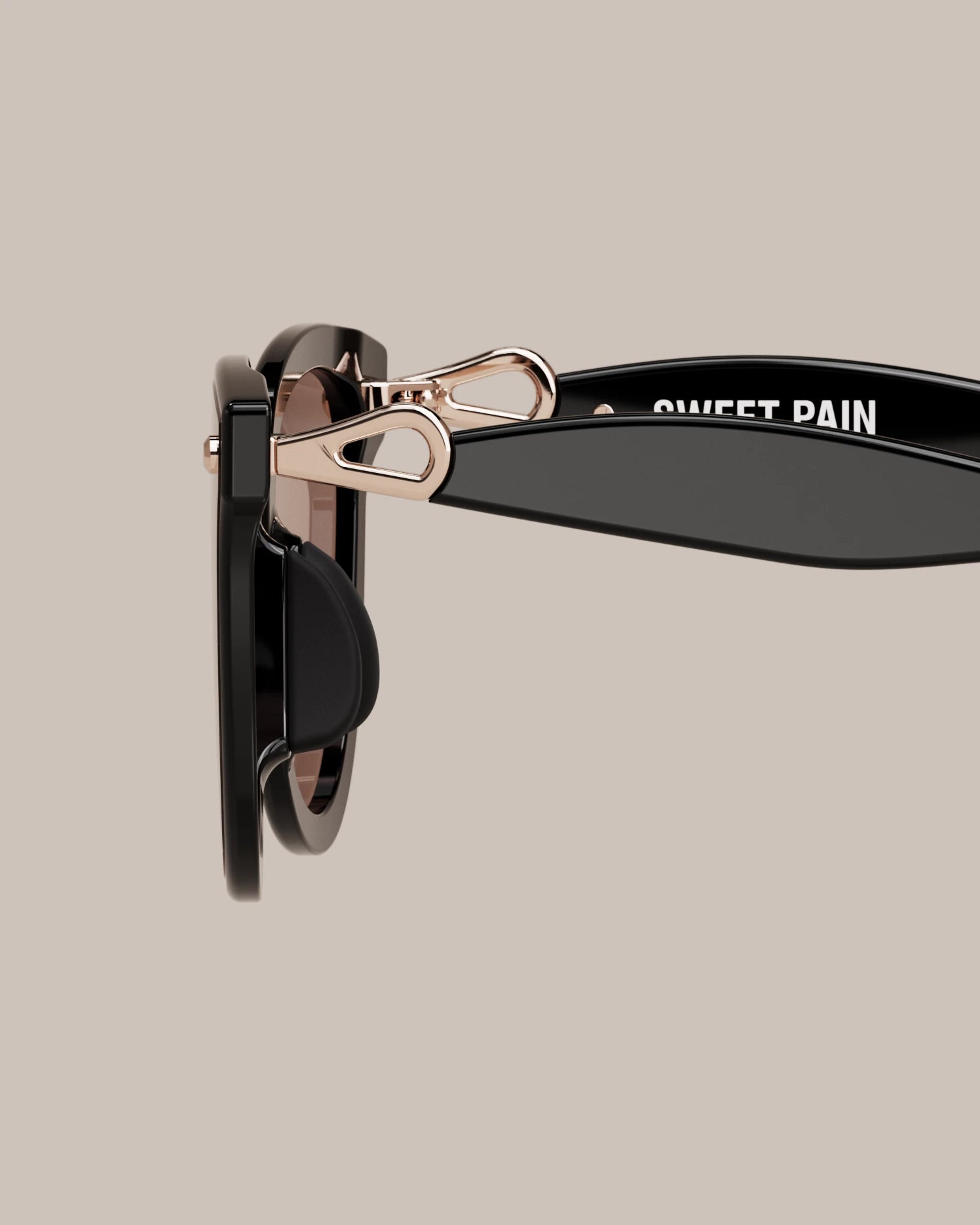 Sweet Pain NANA C1 rose gold hinge detail with Sweet Pain branding on glossy black temple