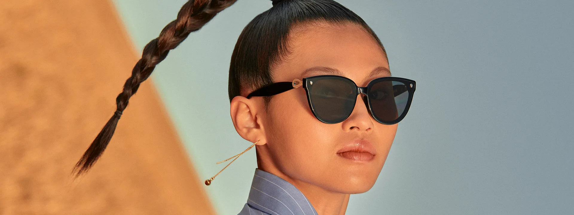 Woman wearing Sweet Pain NANA G1 sunglasses in glossy black, editorial campaign slide
